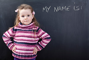 Girl in front of chalkboard